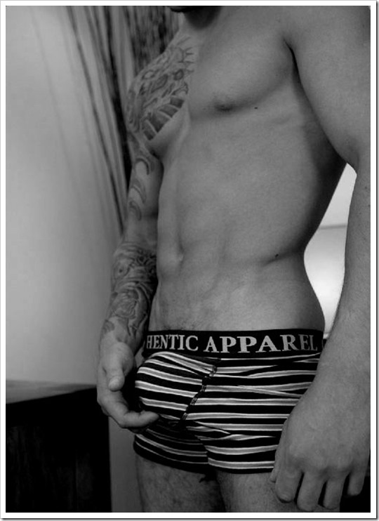 Hot tattoo boy with a bulge in striped boxer briefs