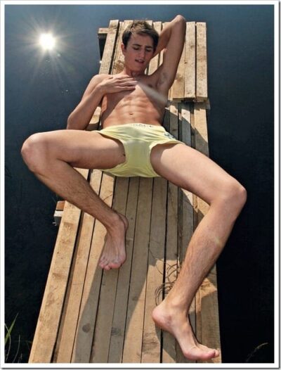 Boy In Yellow Underwear Sunbathing On a Dock
