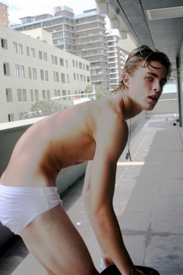Underwear boy finishing and getting dressed on balcony