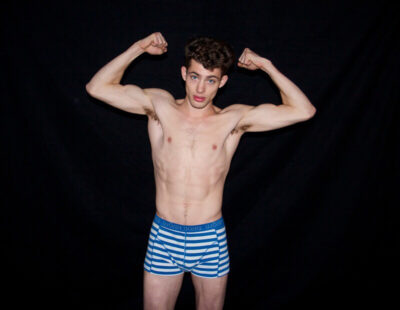 Flexing in Striped Boxer Briefs