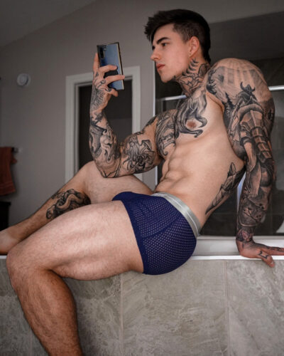 Tattooed Muscle Hunk in Mesh Briefs