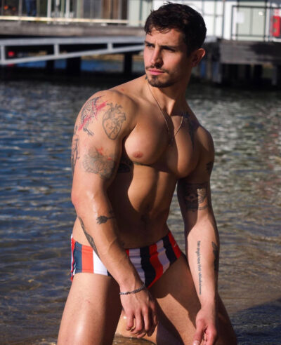 Bulging Pecs in Striped Swim Briefs