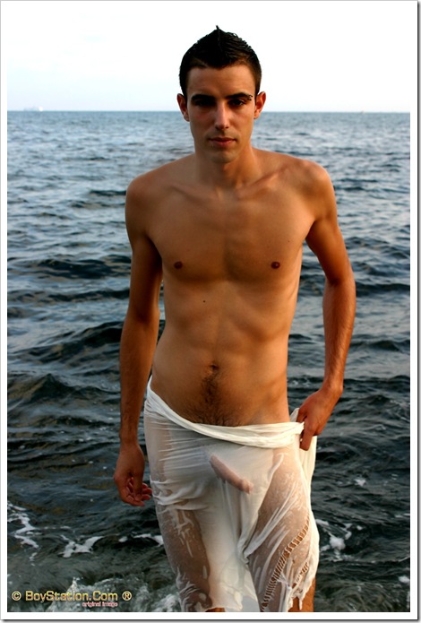 cute boy at the beach with a wet see-thru towel